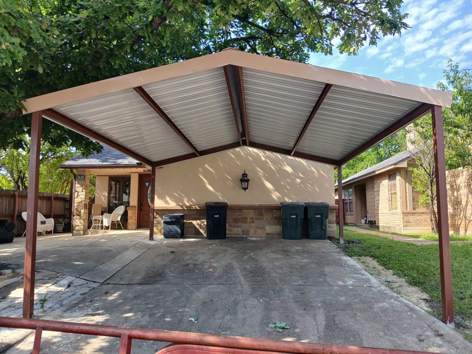 Residential gable-roof metal carport installed by Triple J Metal