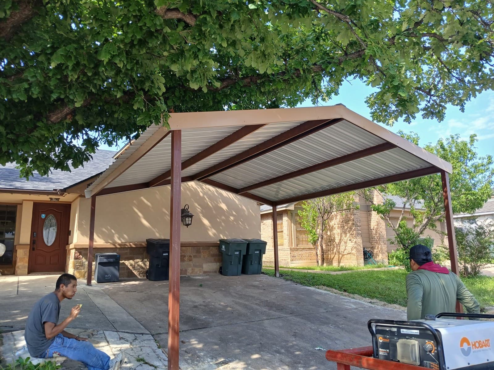 Completed residential metal carport with painted steel panels