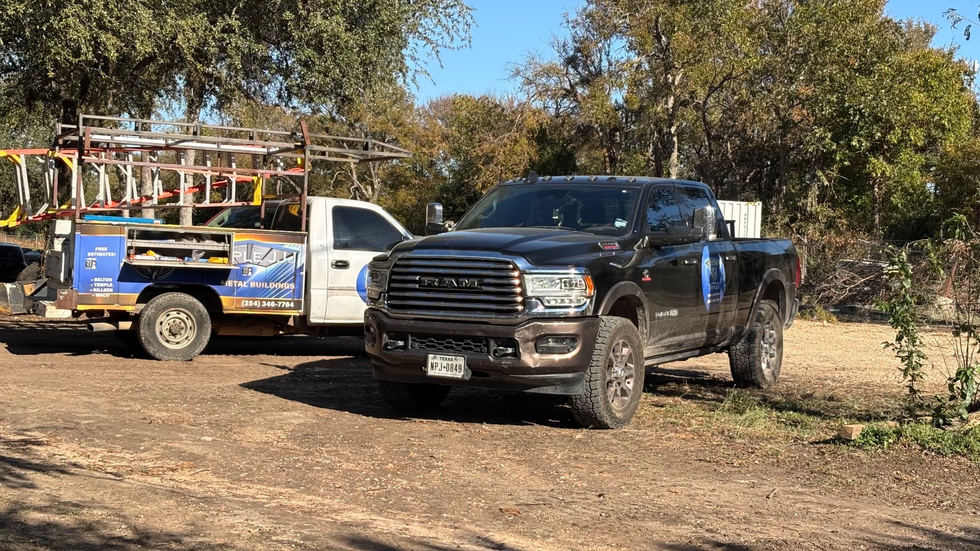 Triple J Metal RAM and second branded work truck on a Central Texas job site