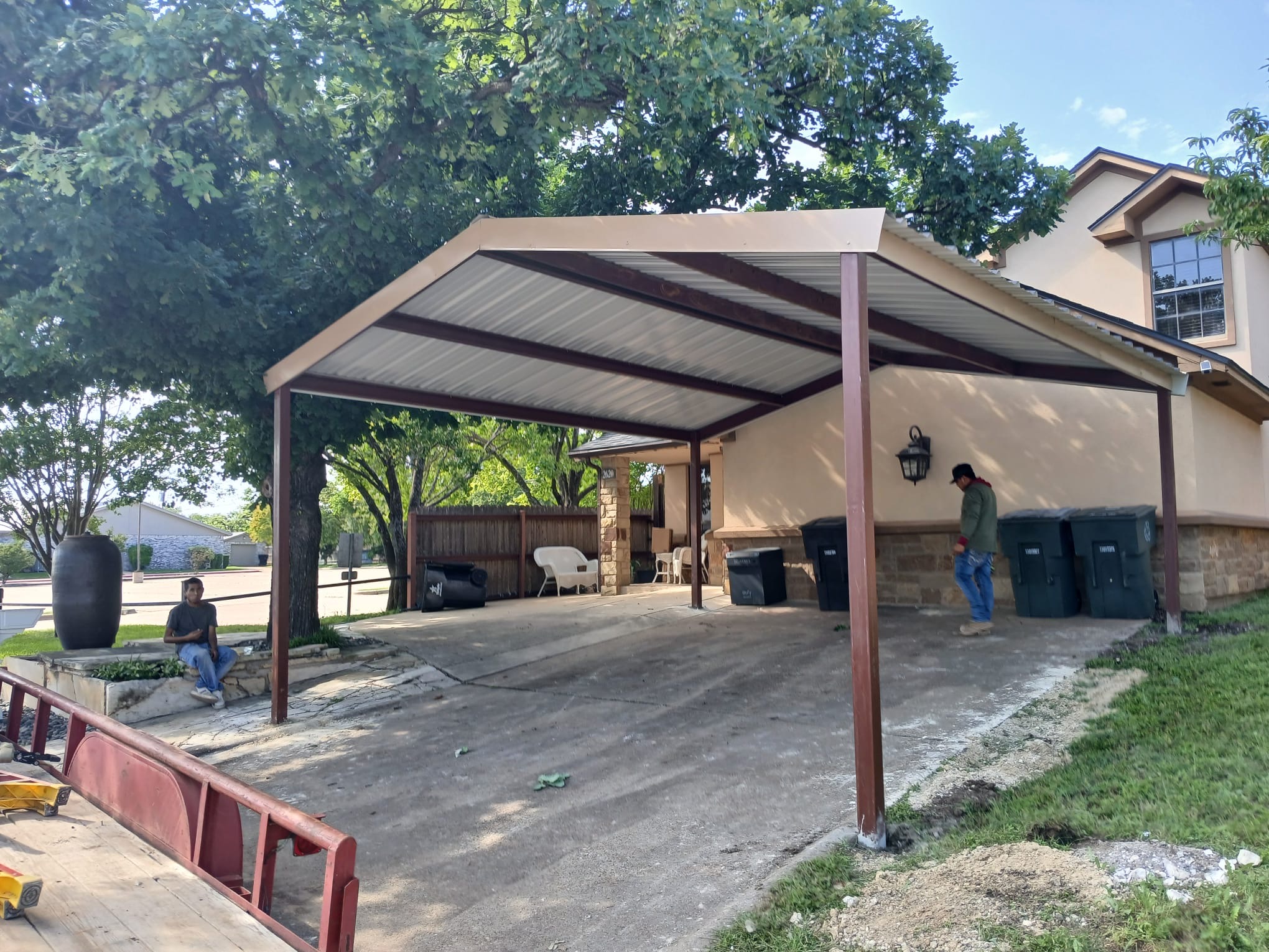 Double-width carport during installation by Triple J crew